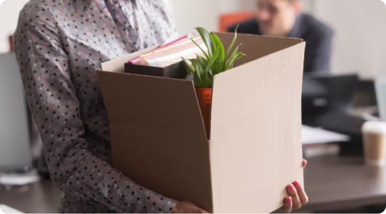 Redundancy 1 working in office carrying box 1